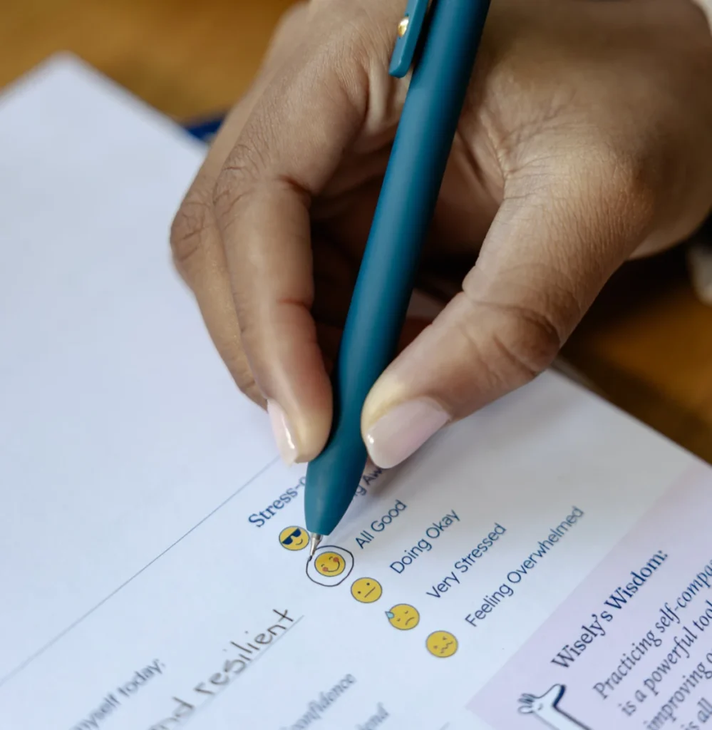 Close-up of someone writing on a page of a Wisely & Co planner